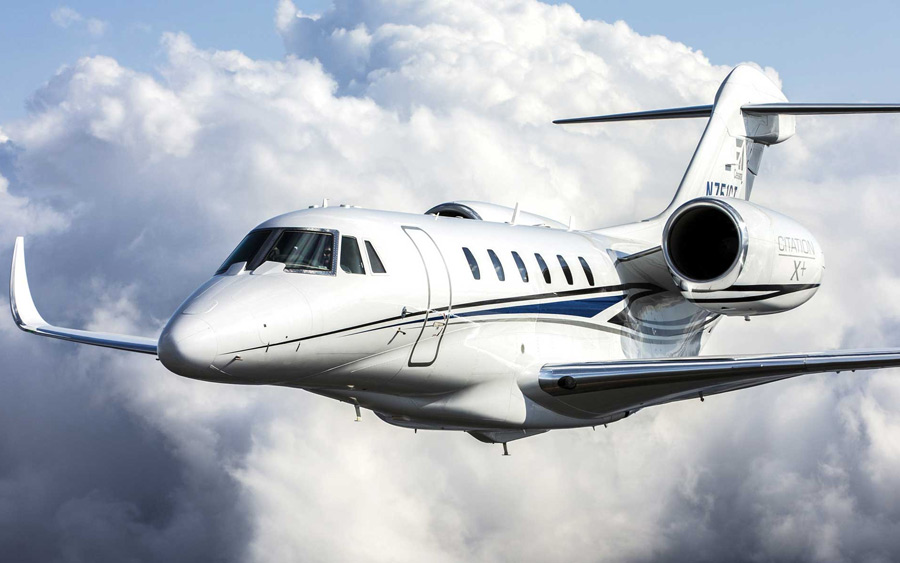 Cessna Citation X flying by clouds