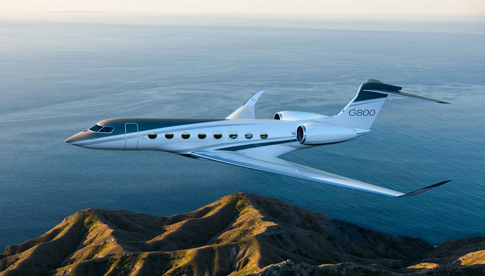Gulfstream G800 side profile flying over green hills