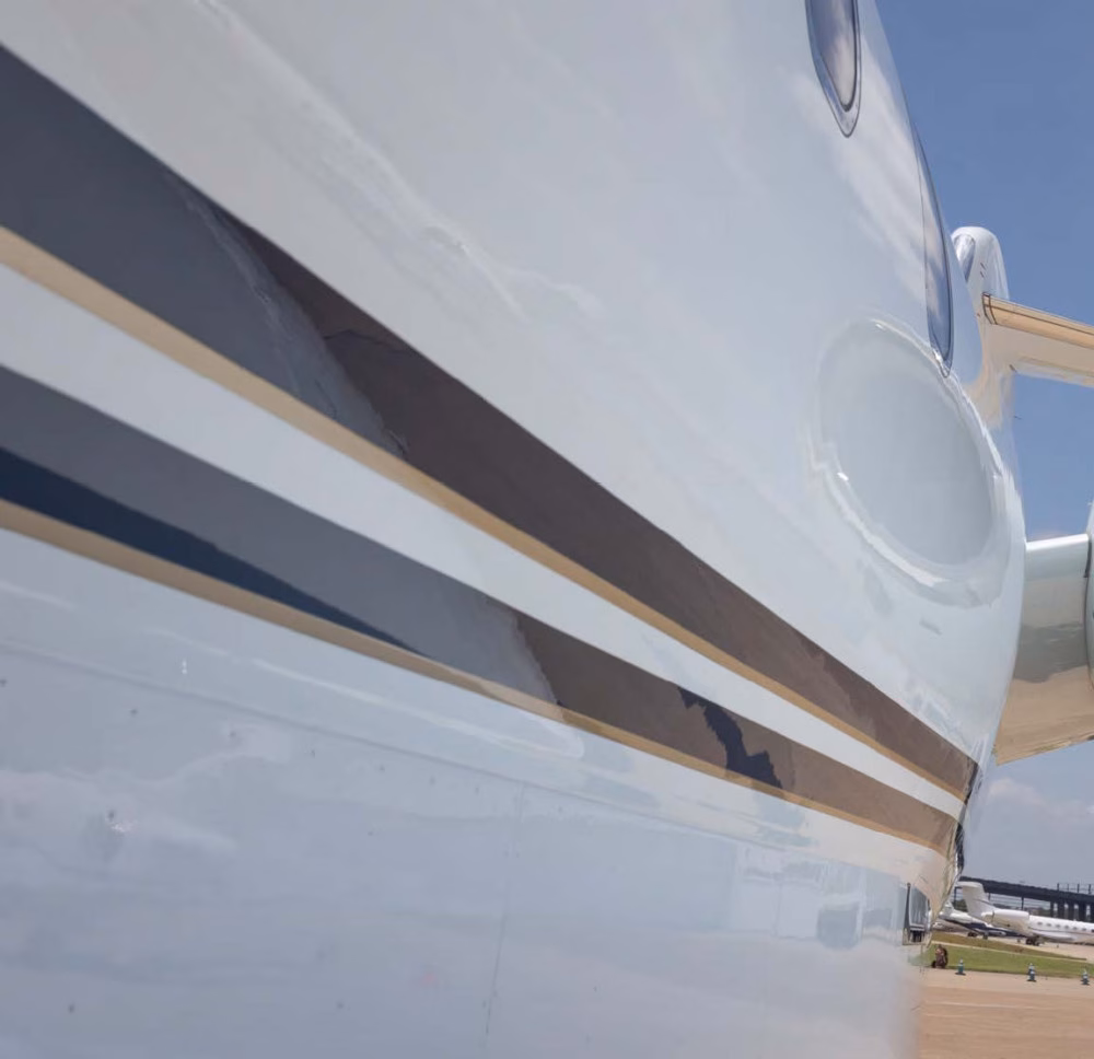 Front angle of Bombardier Challenger 300 N917HP with gold accent stripe