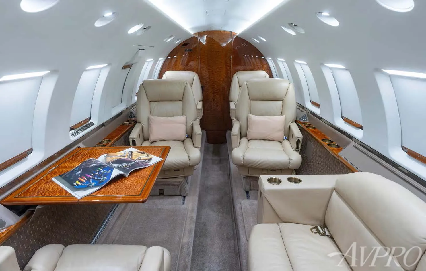 Hawker 800XP cabin interior with executive seating and wood finish tables