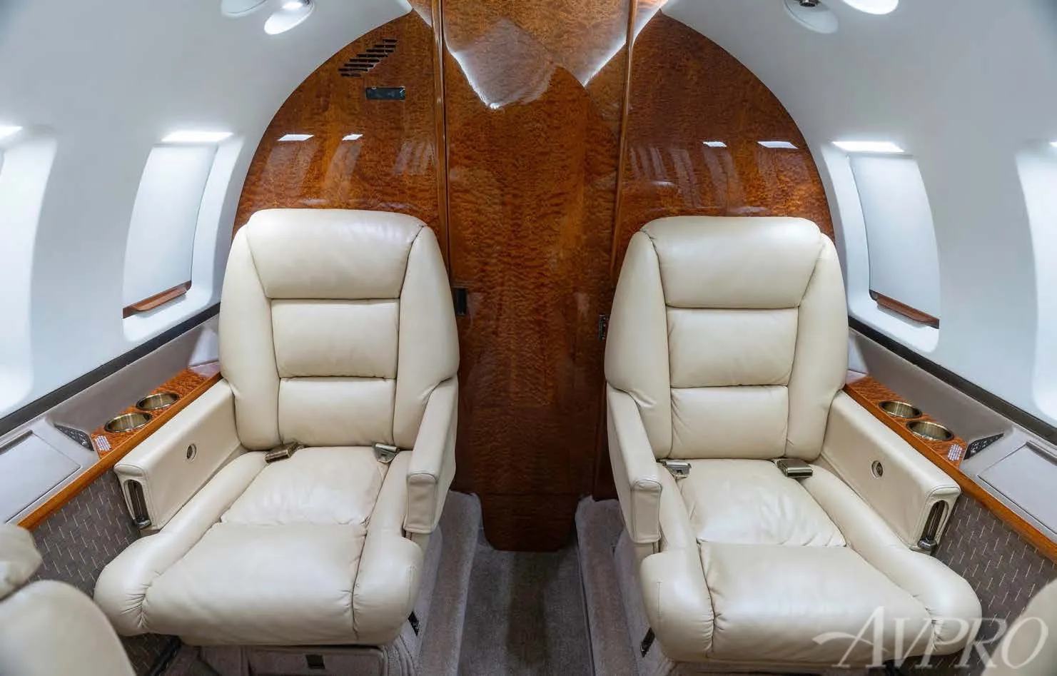 Hawker 800XP passenger seating with leather chairs and wood cabin finish