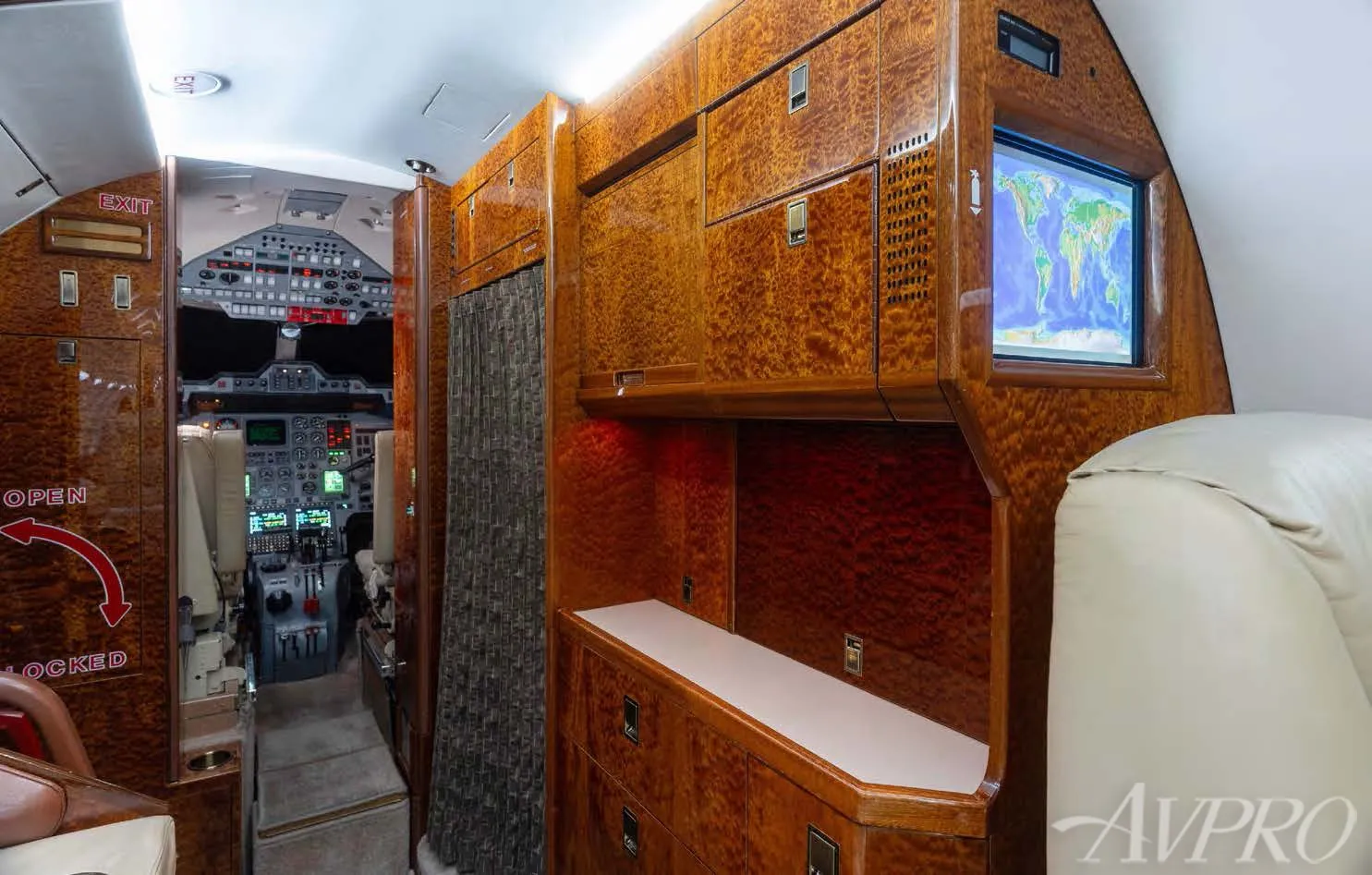 Hawker 800XP forward galley and cockpit entry with wood cabinetry