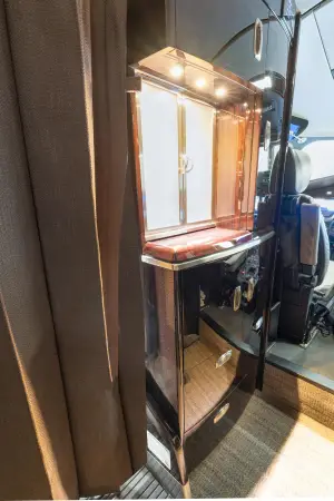 2018 Cessna Citation Latitude refreshment cabinet with glossy wood veneer and illuminated storage