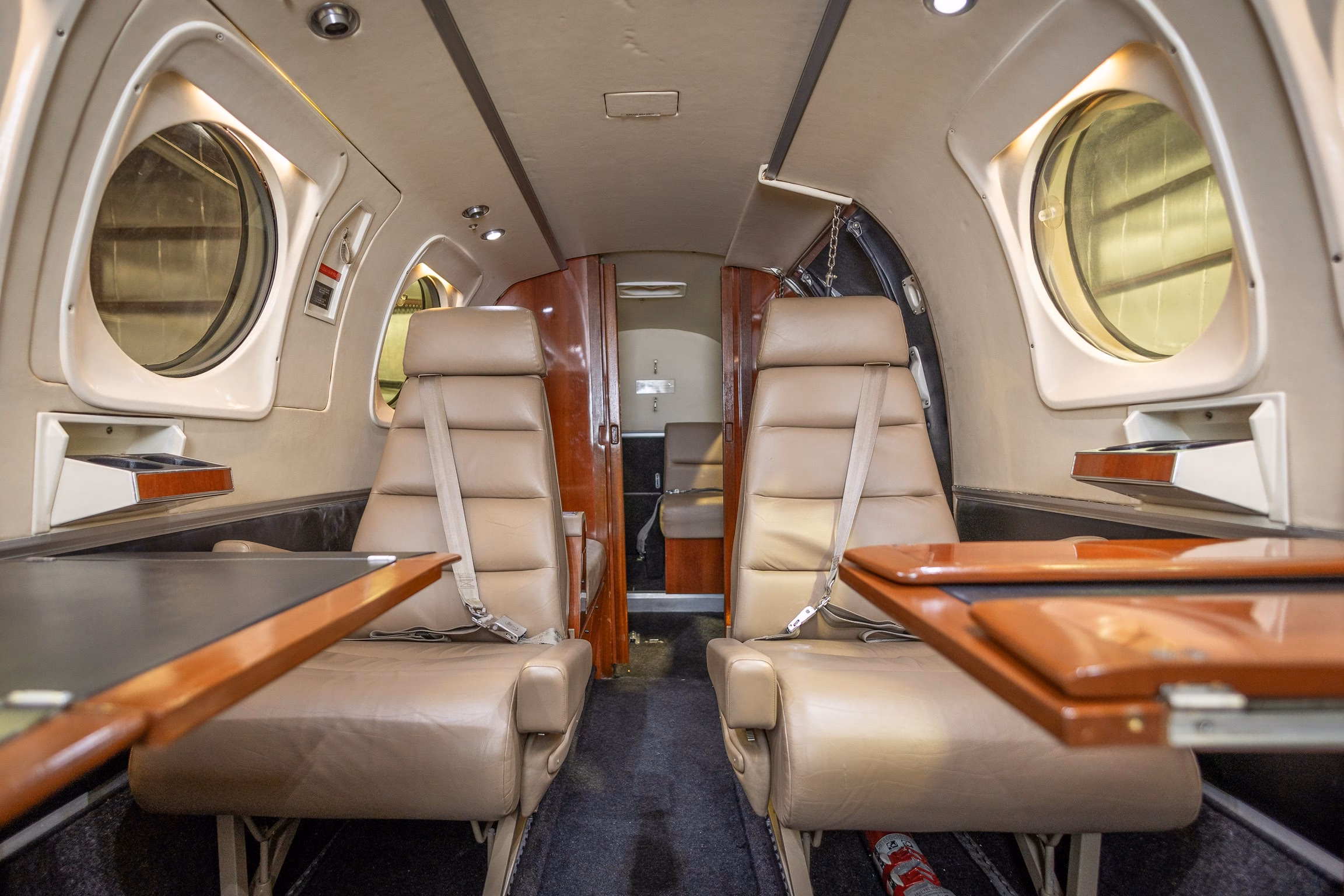 1982 Beechcraft King Air C90 cabin interior with club seating and aft belted lavatory seat
