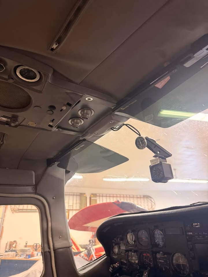 1979 Cessna 210N N7AL cockpit overhead panel and windshield view
