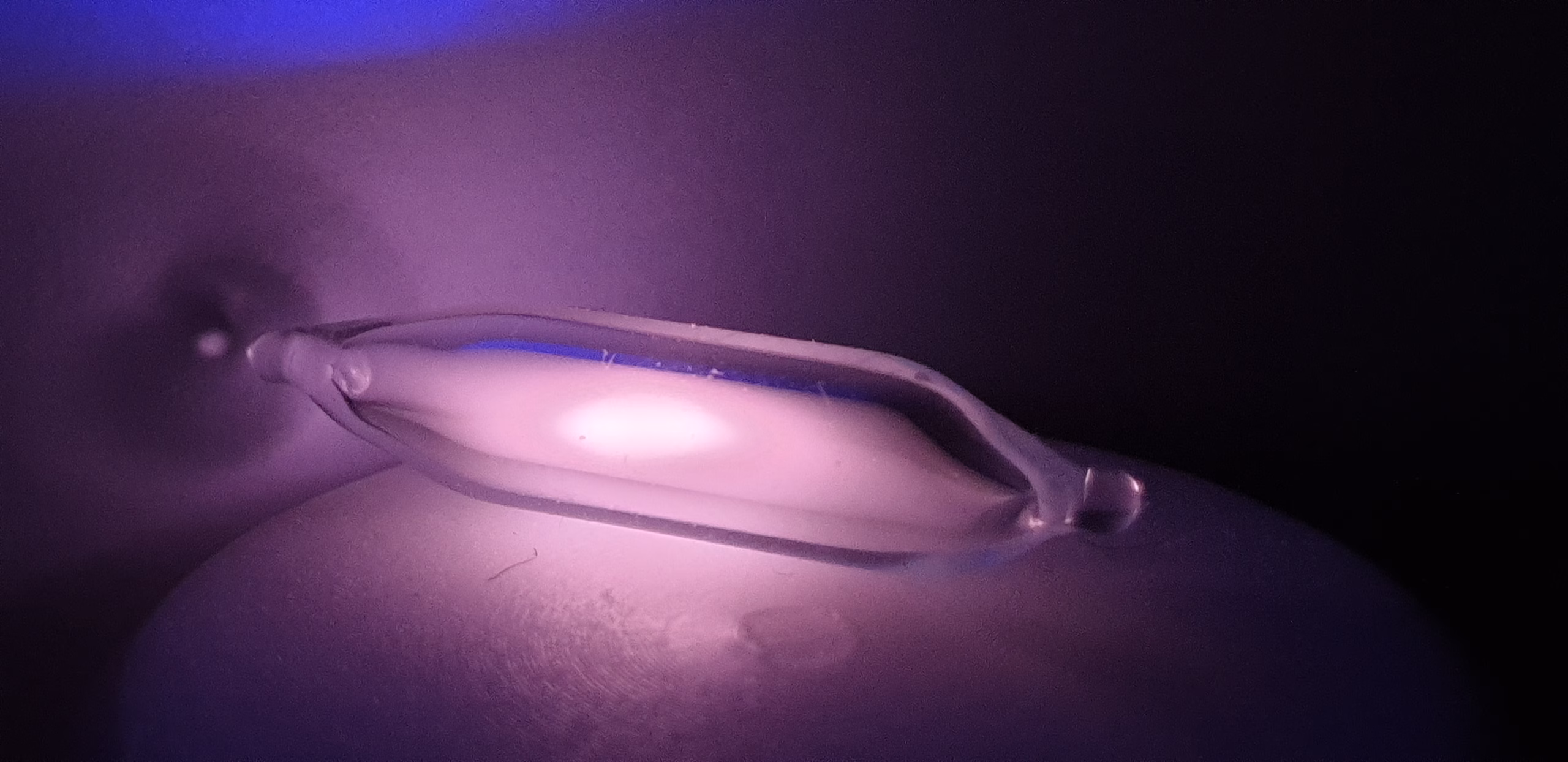 Laboratory image of excited helium-3 glowing inside a glass discharge tube